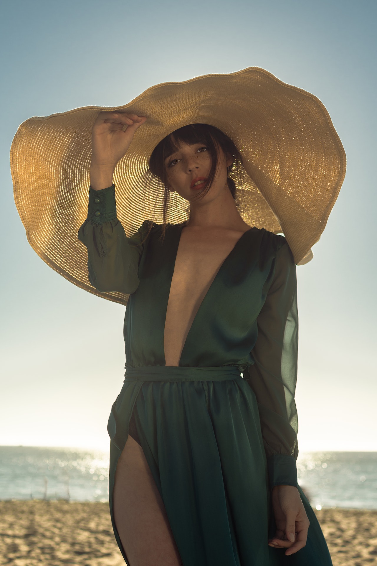 Woman is wearing a green dress and hat