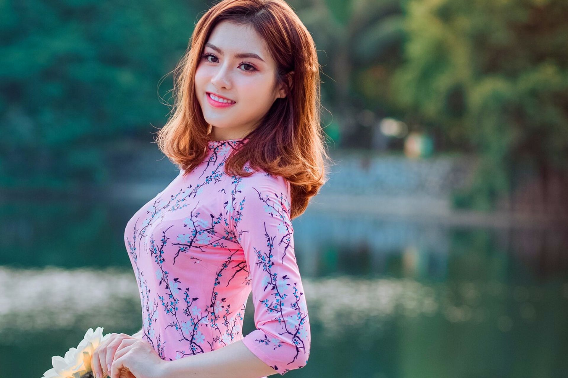 Korean girl wearing pink colored dress is smailing