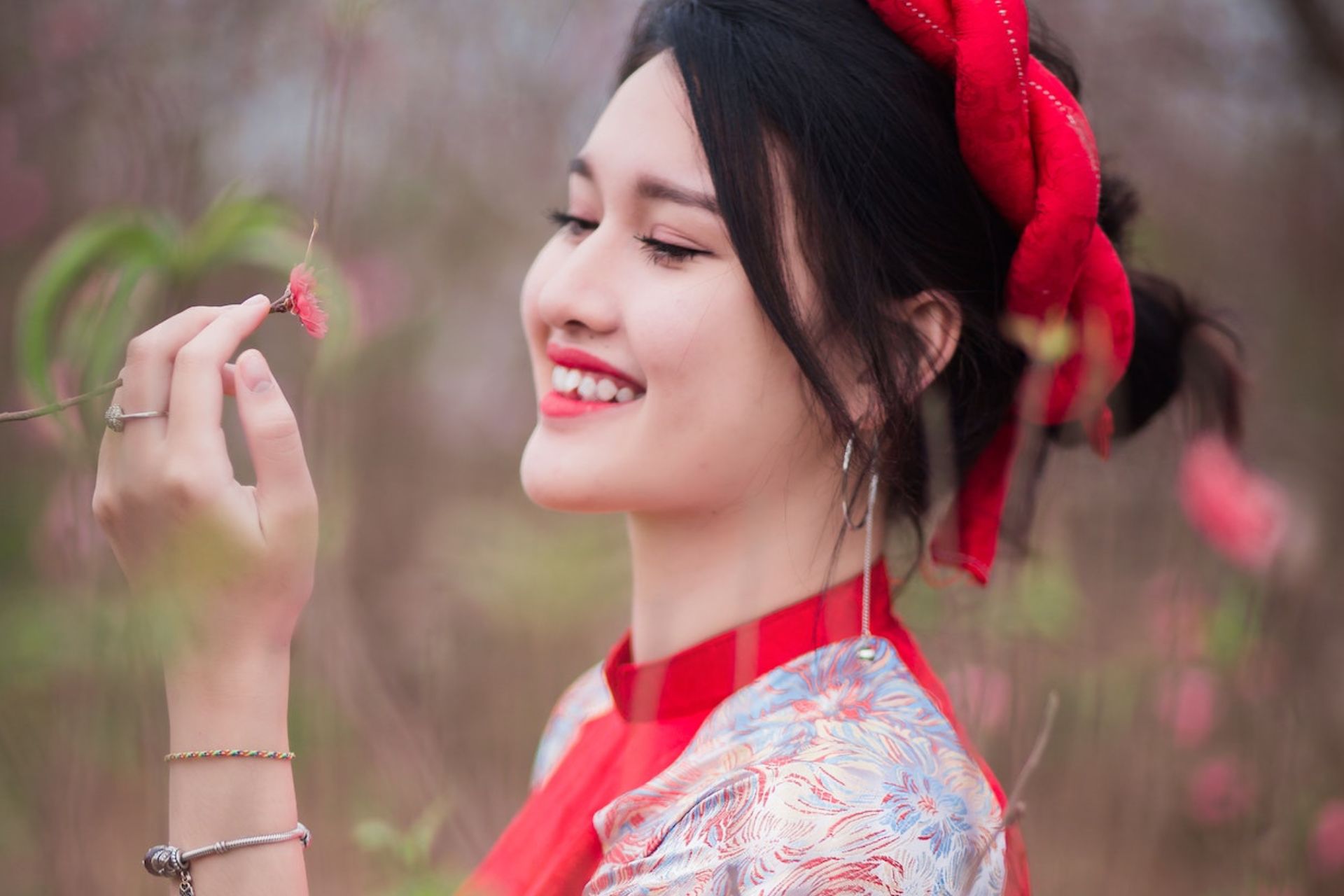 Smiling korean girl wearing red ribbon at hair