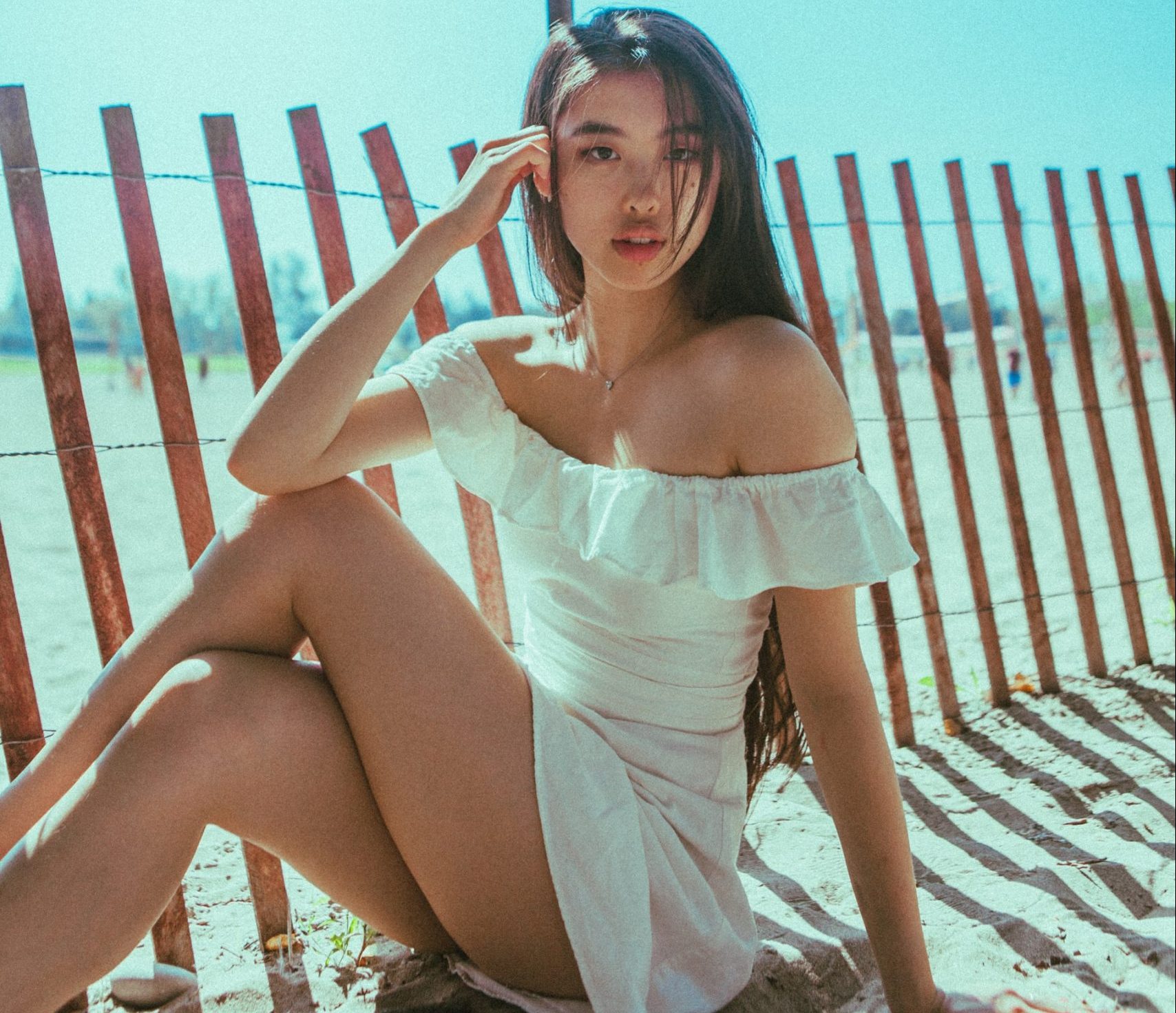 Korean girl wearing white top sitting on the ground