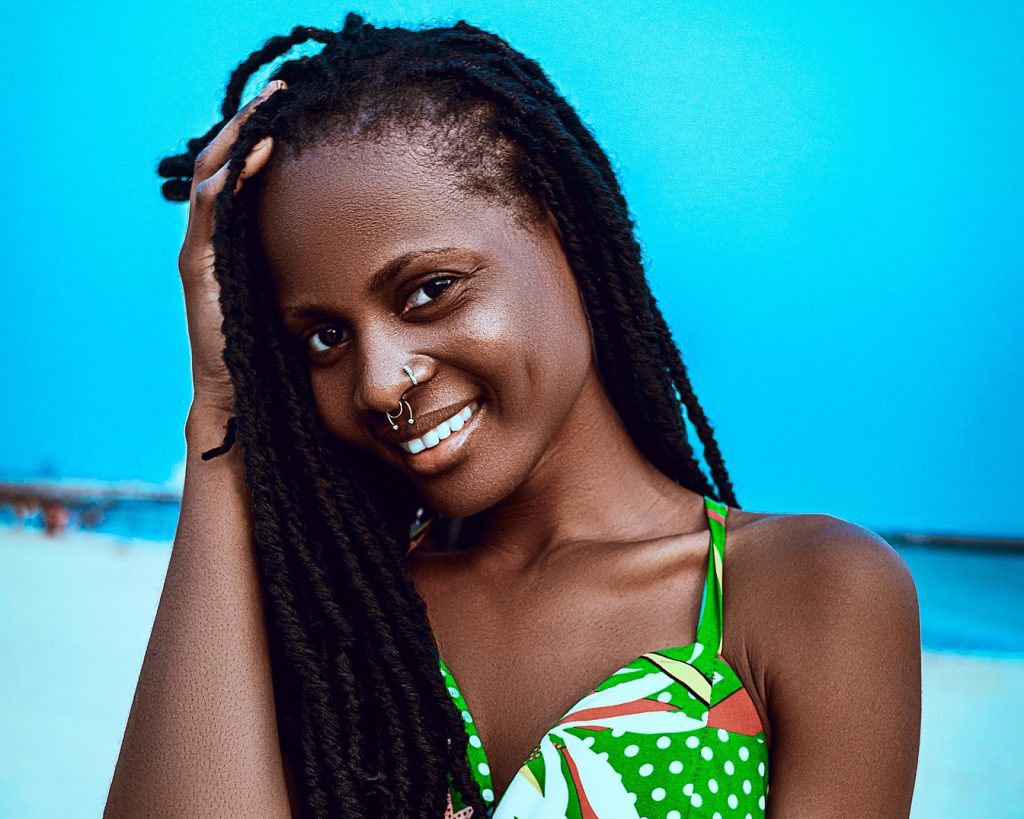 Nigerian model wearing green top smiling