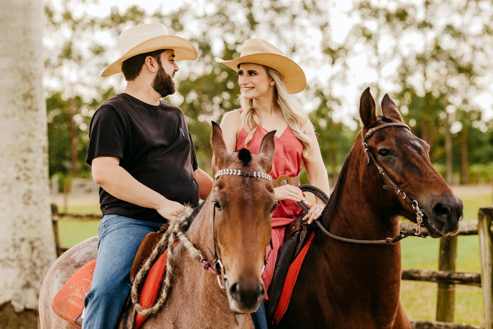 western man and woman riding a horse