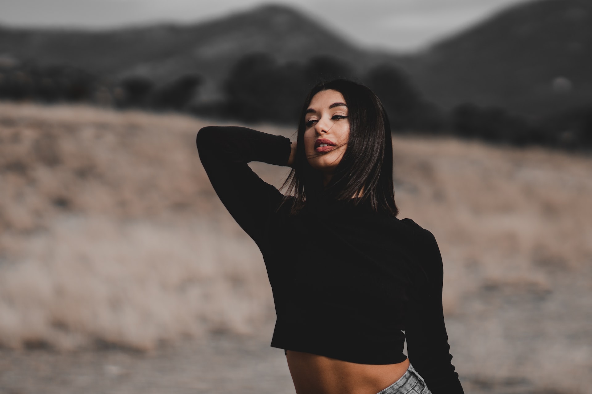 Greek beauty wearing a black top standing in forest