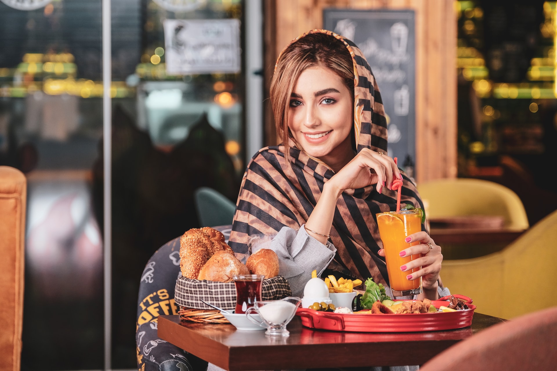Beautiful iranian girl drinking a orange juice