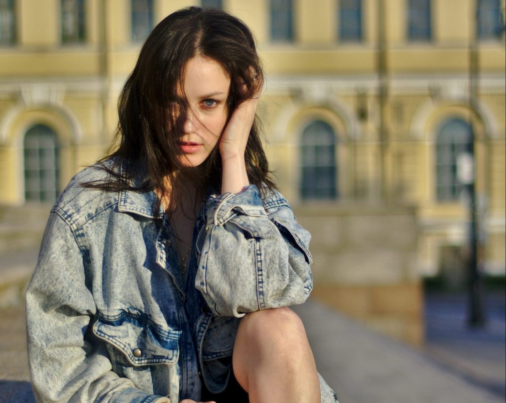 Russian Girl wearing Denim blue jacket sitting on the steps