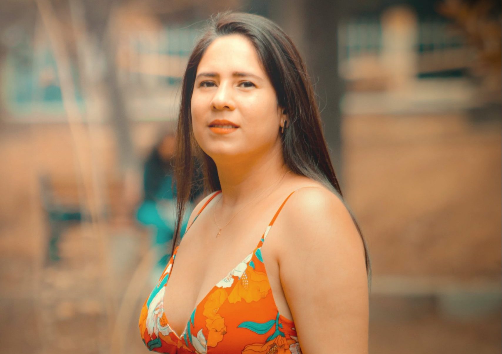 beautiful Peruvian wearing a orange coloured top