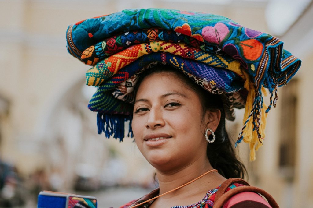 Guatemalan woman carrying pieces of clothes