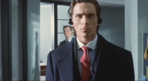patric bateman in a suite and red tie