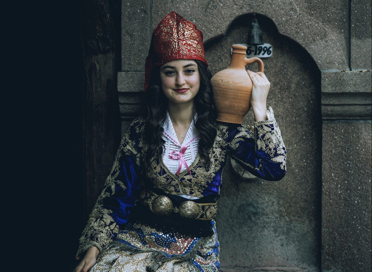 turkish woman smiling and wearing a traditional costume